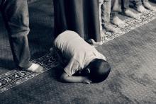 Young child forced to kneel and pray